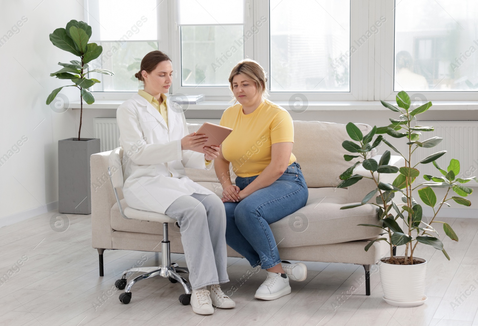 Weight loss. Nutritionist consulting overweight woman in clinic Photo of Weight loss. Nutritionist consulting overweight woman in clinic
