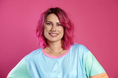Photo of Beautiful woman with bright dyed hair on pink background