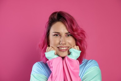 Photo of Beautiful woman with bright dyed hair on pink background