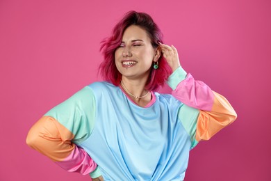 Photo of Beautiful woman with bright dyed hair on pink background
