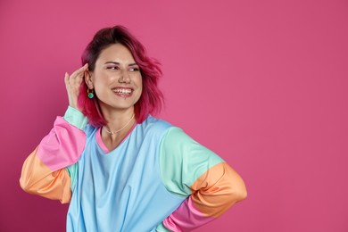 Photo of Beautiful woman with bright dyed hair on pink background, space for text