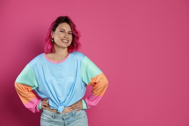 Photo of Beautiful woman with bright dyed hair on pink background, space for text