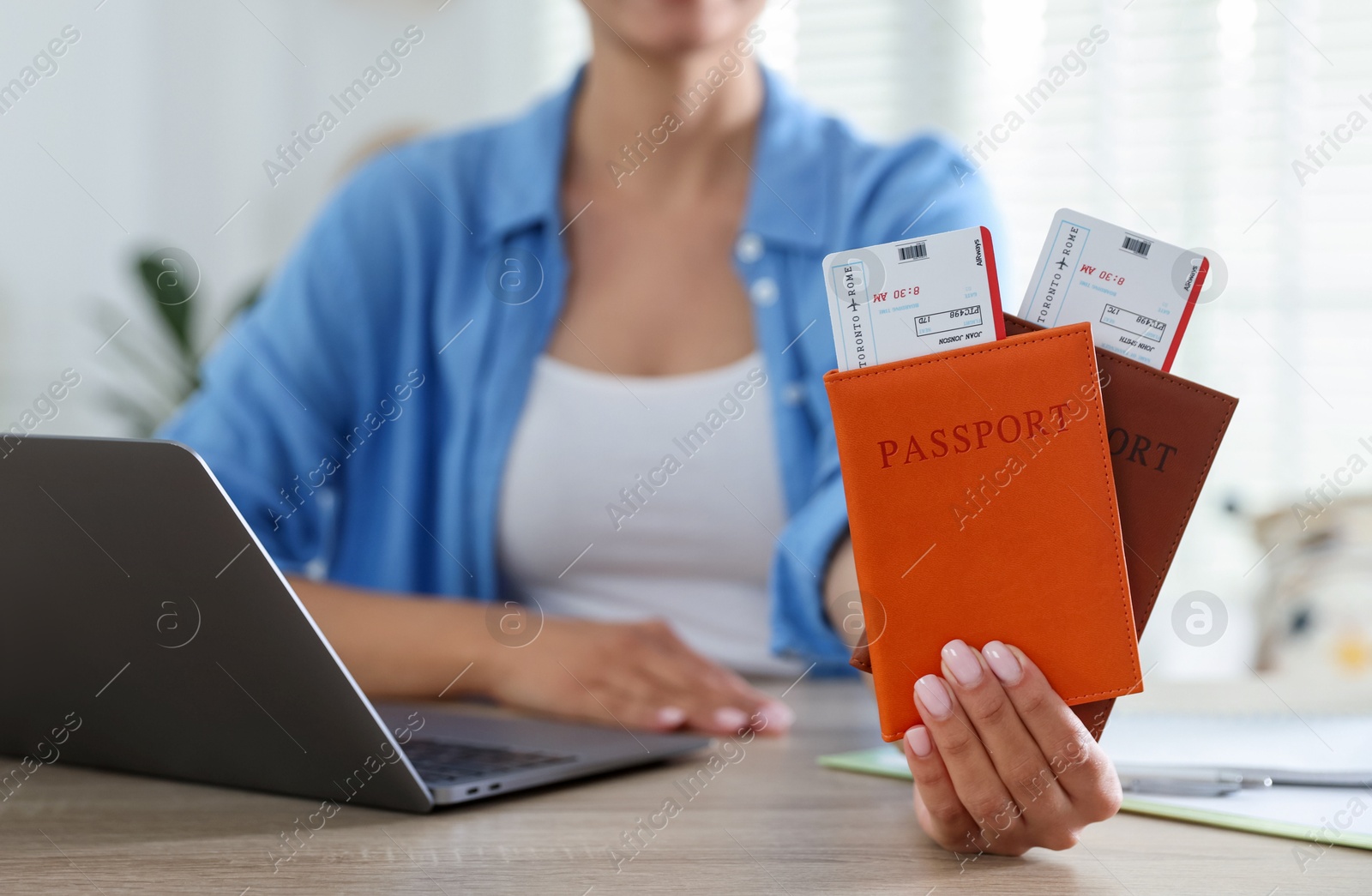Travel agent with passports and tickets at wooden table in office, closeup Photo of Travel agent with passports and tickets at wooden table in office, closeup