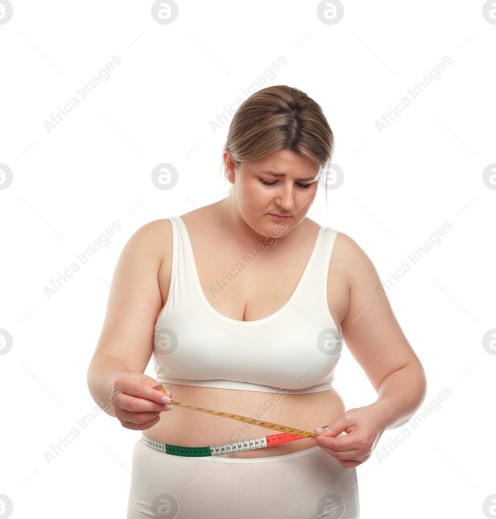 Weight loss. Plus size woman measuring waist with tape on white background Photo of Weight loss. Plus size woman measuring waist with tape on white background