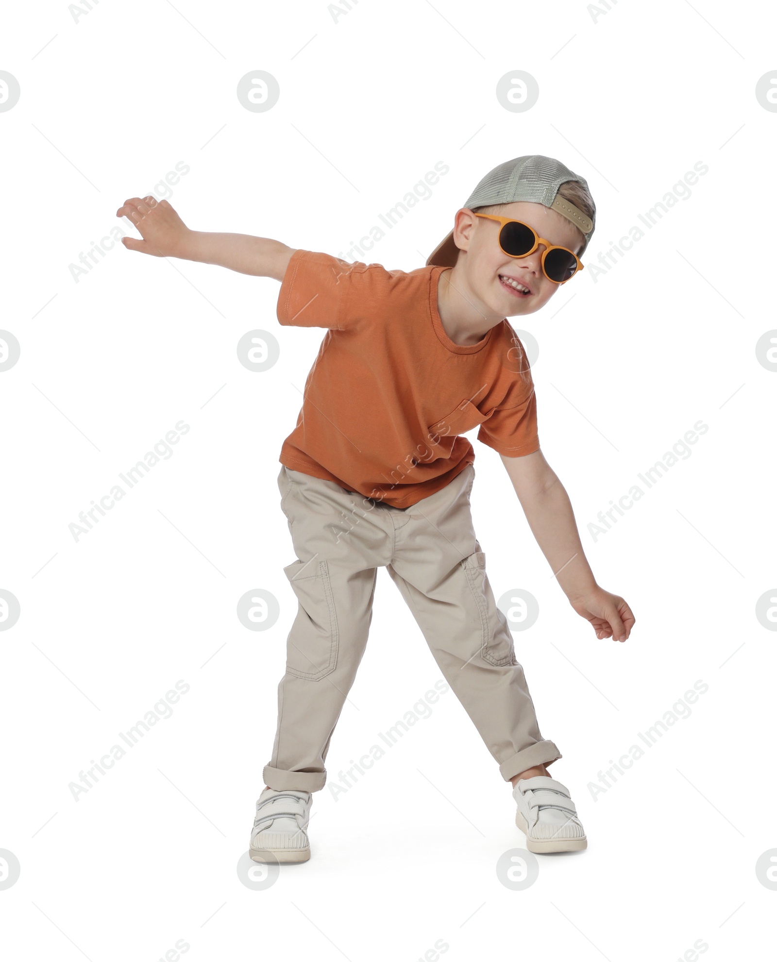 Happy little boy with sunglasses dancing on white background Photo of Happy little boy with sunglasses dancing on white background