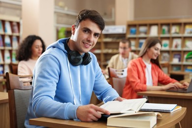 Photo of People studying at desks in public library, selective focus