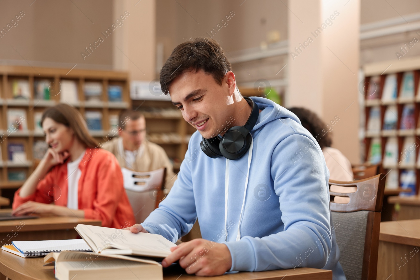 People studying at desks in public library, selective focus Photo of People studying at desks in public library, selective focus