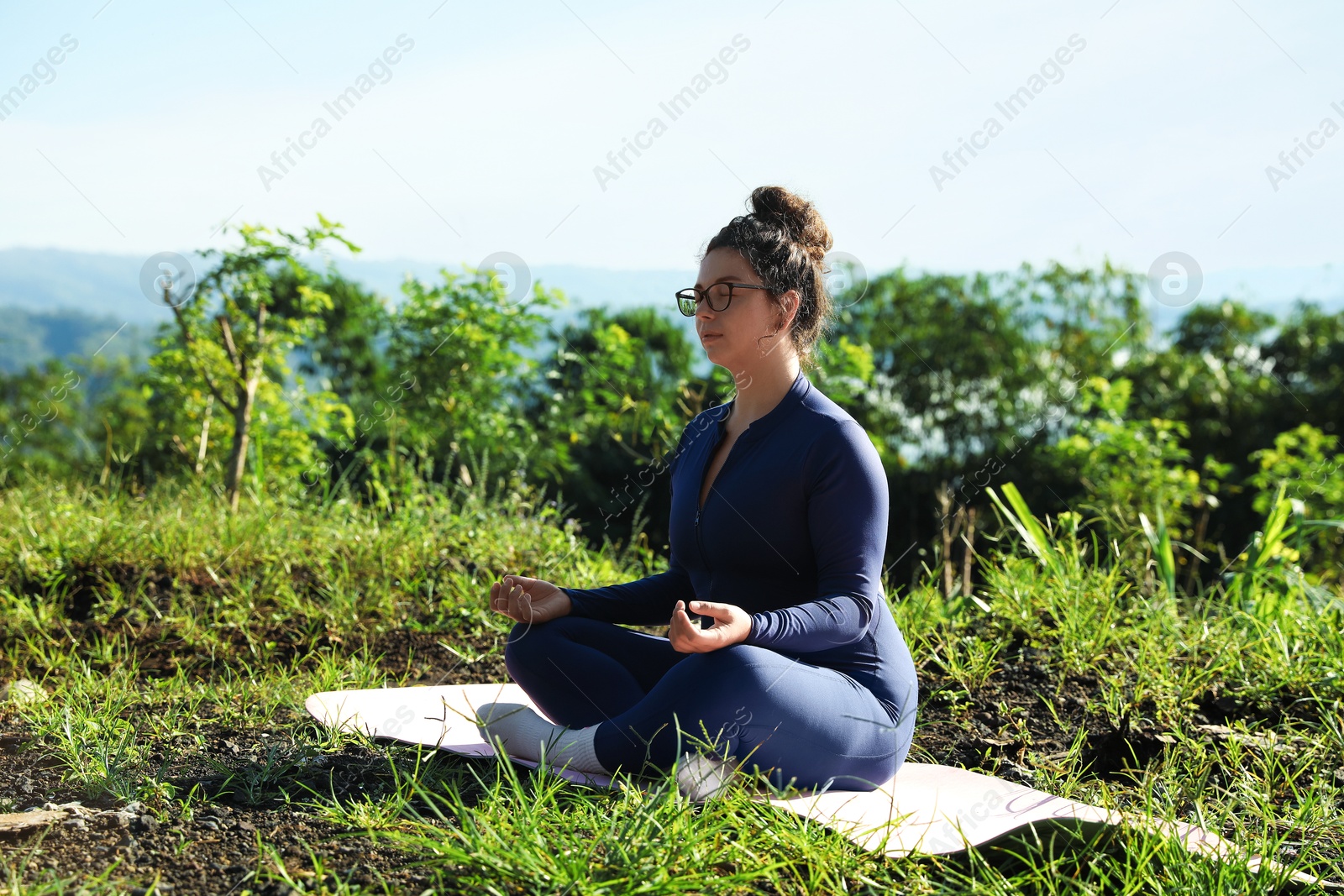 Woman meditating on yoga mat outdoors. Space for text Photo of Woman meditating on yoga mat outdoors. Space for text