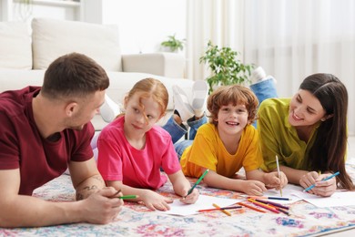 Photo of Parents teaching their kids to draw on floor at home