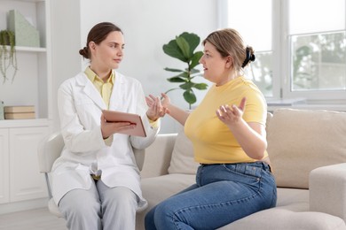 Photo of Weight loss. Nutritionist consulting overweight woman in clinic