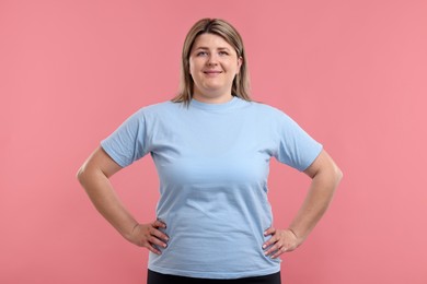 Photo of Weight loss. Plus size woman on pink background