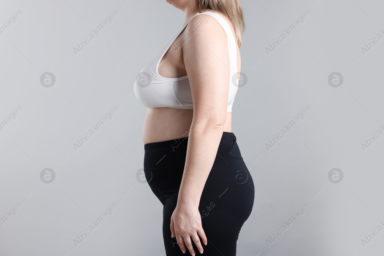 Weight loss. Plus size woman on gray background, closeup Photo of Weight loss. Plus size woman on gray background, closeup