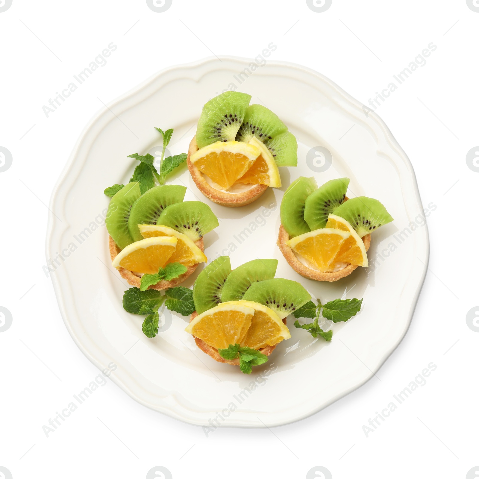 Tartlets with fruits and mint isolated on white, top view. Delicious dessert Photo of Tartlets with fruits and mint isolated on white, top view. Delicious dessert
