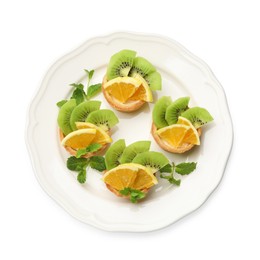 Photo of Tartlets with fruits and mint isolated on white, top view. Delicious dessert