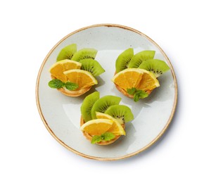 Photo of Tartlets with fruits and mint isolated on white, top view. Delicious dessert