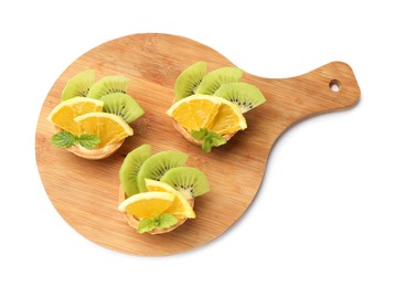 Photo of Tartlets with fruits and mint isolated on white, top view. Delicious dessert