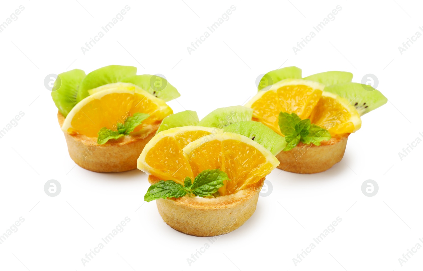 Tartlets with fruits and mint isolated on white. Delicious dessert Photo of Tartlets with fruits and mint isolated on white. Delicious dessert