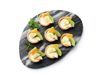 Photo of Tartlets with fruits and mint isolated on white, top view. Delicious dessert