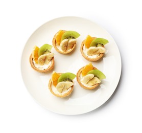 Photo of Tartlets with fruits isolated on white, top view. Delicious dessert