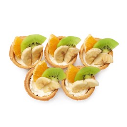 Photo of Tartlets with fruits isolated on white, top view. Delicious dessert