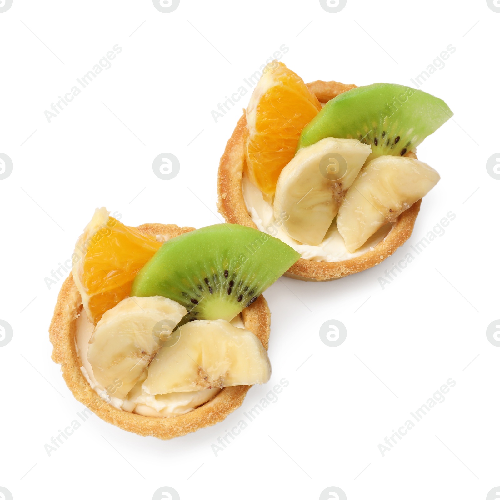 Tartlets with fruits isolated on white, top view. Delicious dessert Photo of Tartlets with fruits isolated on white, top view. Delicious dessert