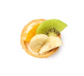 Photo of Tartlet with orange, banana and kiwi isolated on white, top view. Delicious dessert