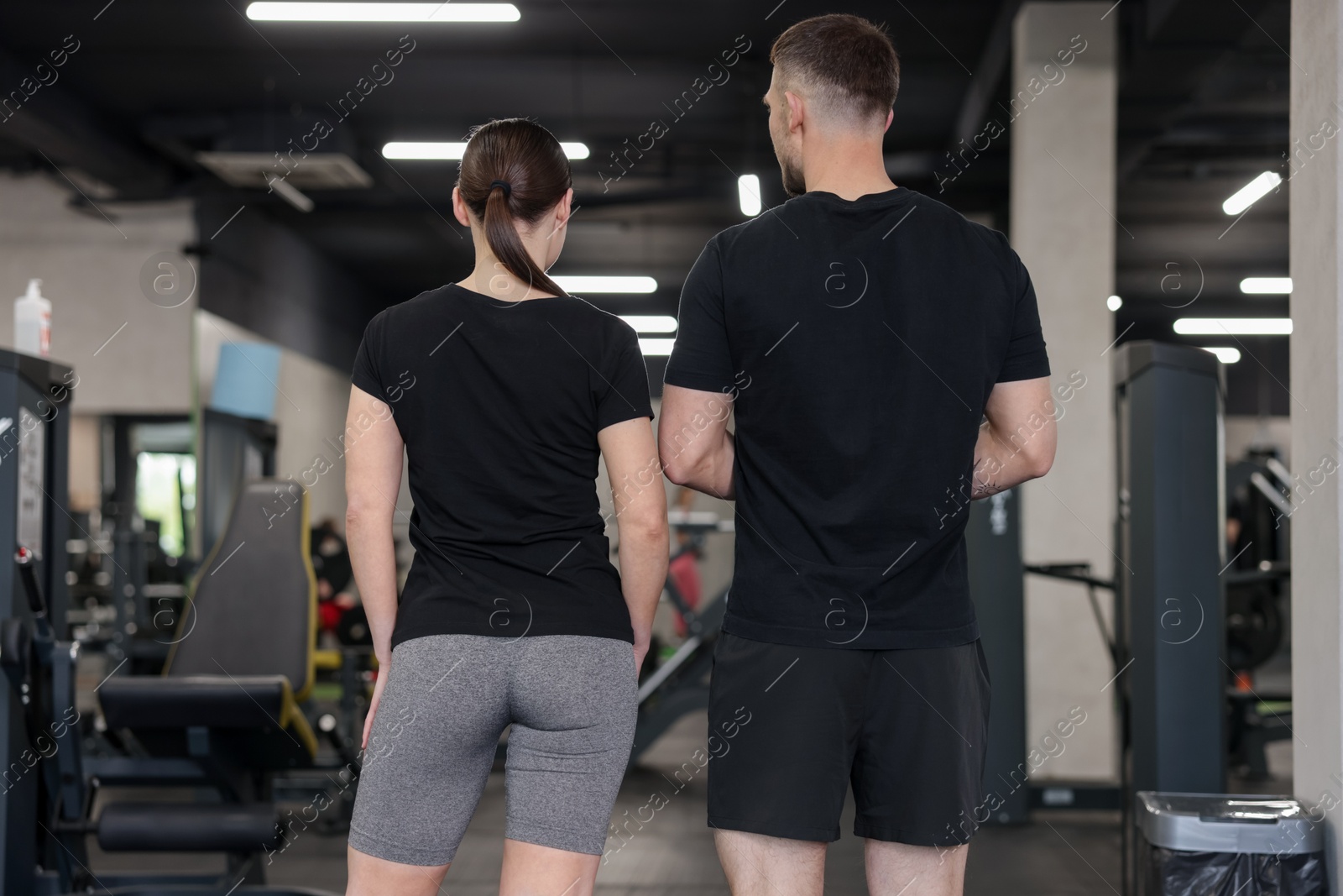 Personal trainers in sport center, back view Photo of Personal trainers in sport center, back view