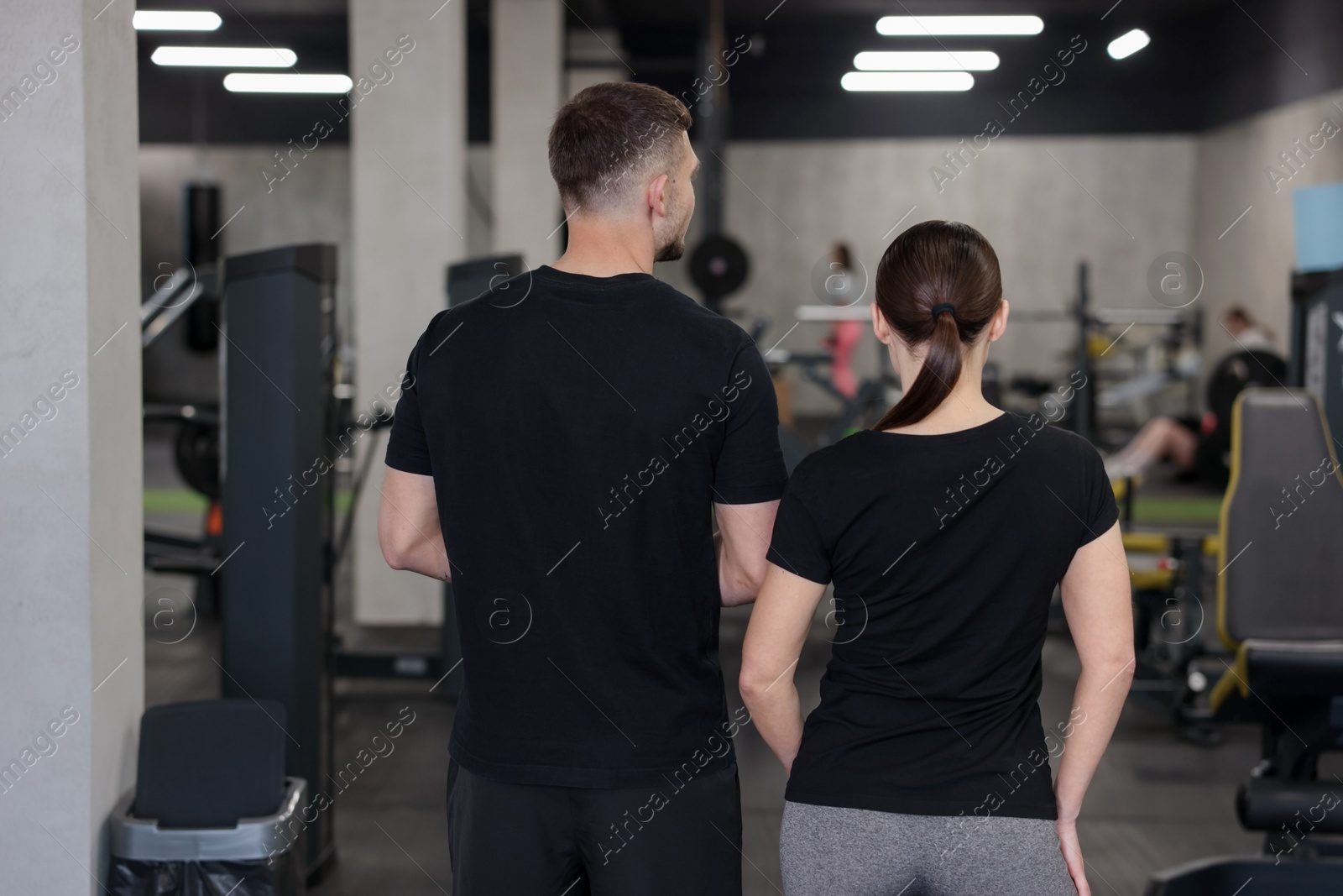 Personal trainers in sport center, back view Photo of Personal trainers in sport center, back view