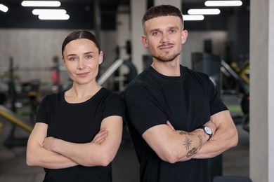 Photo of Portrait of professional personal trainers in sport center