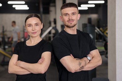 Photo of Portrait of professional personal trainers in sport center