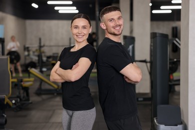 Photo of Portrait of professional personal trainers in sport center