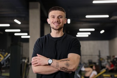 Photo of Portrait of professional personal trainer in sport center