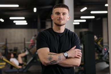 Photo of Portrait of professional personal trainer in sport center