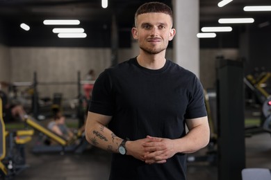 Photo of Portrait of professional personal trainer in sport center