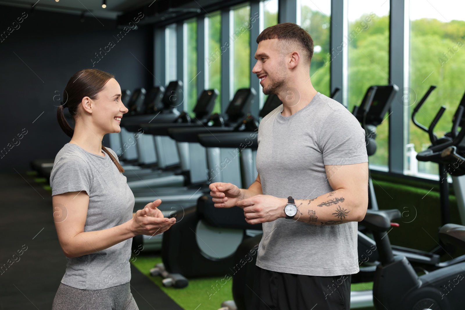 Professional personal trainers talking in sport center Photo of Professional personal trainers talking in sport center