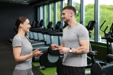 Photo of Professional personal trainers talking in sport center