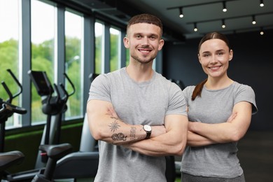 Photo of Portrait of personal trainers in sport center