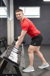 Photo of Professional personal trainer with dumbbells in gym