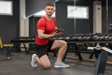 Photo of Personal trainer with tablet in sport center