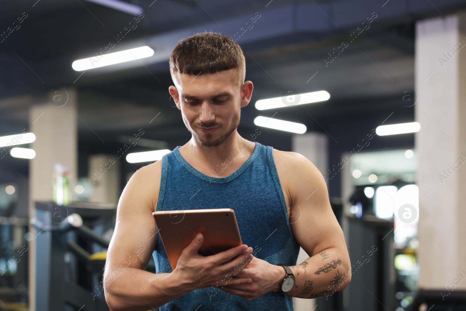 Personal trainer with tablet in sport center Photo of Personal trainer with tablet in sport center