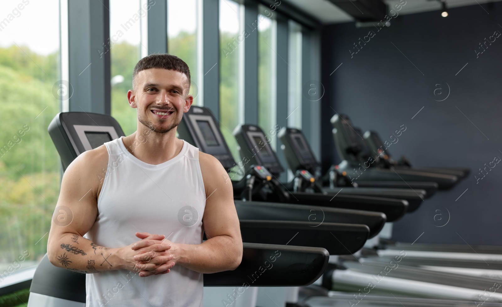 Portrait of professional personal trainer in sport center. Space for text Photo of Portrait of professional personal trainer in sport center. Space for text
