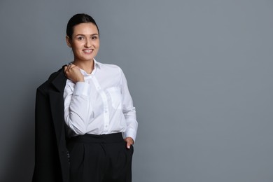 Photo of Confident business woman in suit on grey background. Space for text