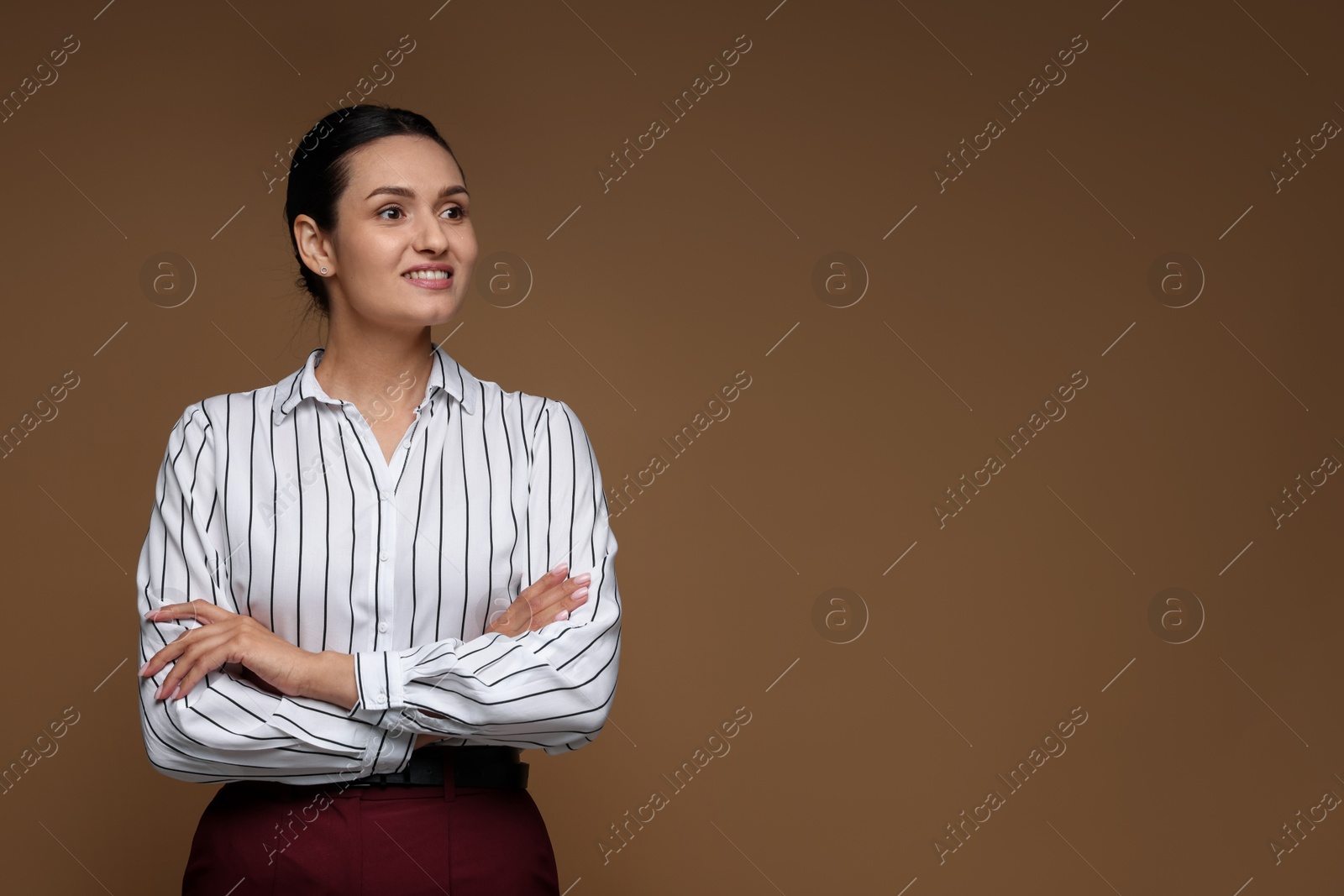Portrait of confident business woman on brown background. Space for text Photo of Portrait of confident business woman on brown background. Space for text