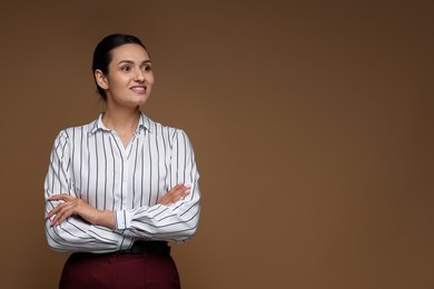 Photo of Portrait of confident business woman on brown background. Space for text
