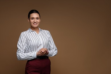 Photo of Portrait of confident business woman on brown background. Space for text