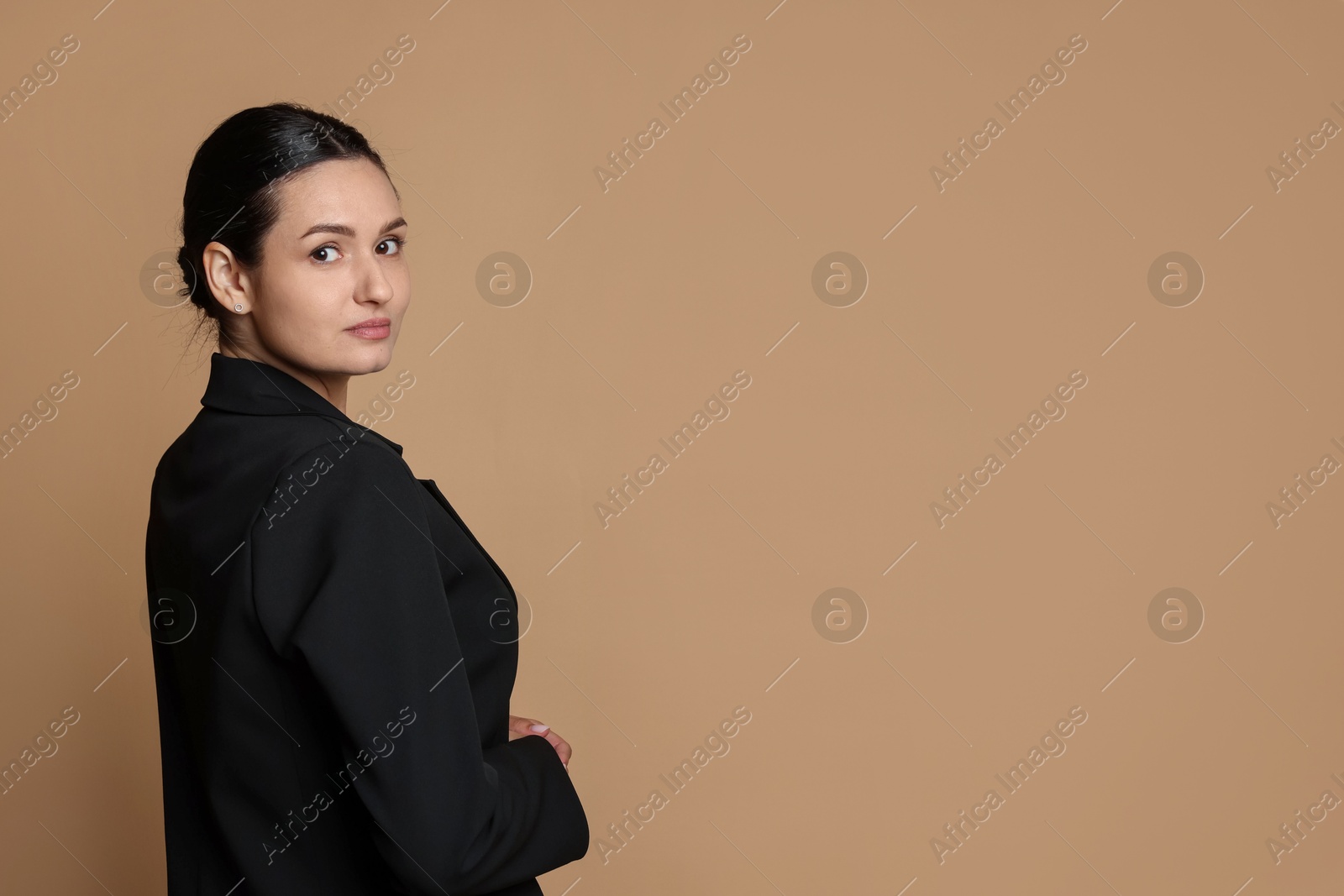 Confident business woman in suit on beige background. Space for text Photo of Confident business woman in suit on beige background. Space for text