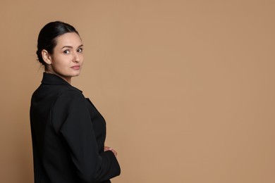 Photo of Confident business woman in suit on beige background. Space for text