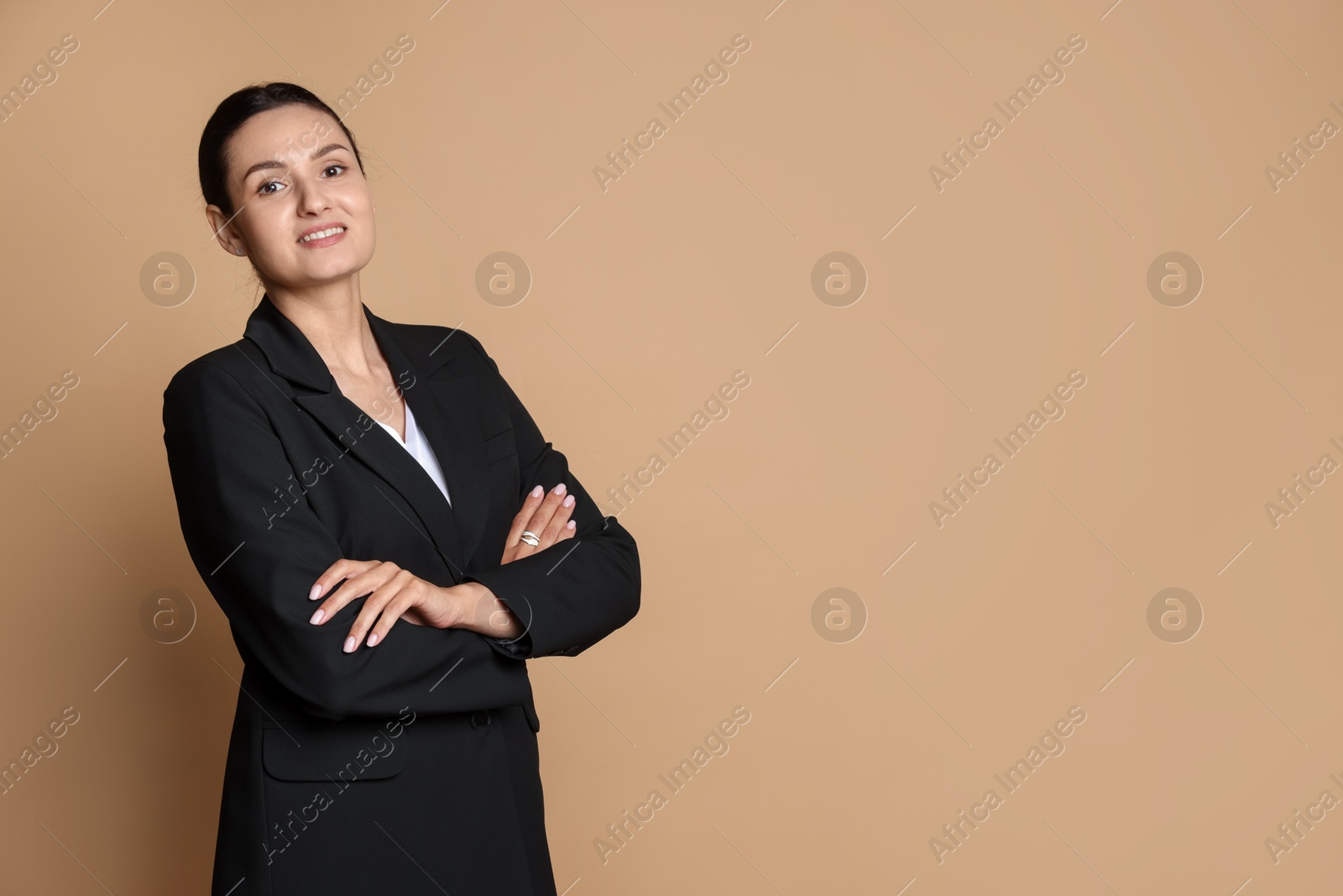 Confident business woman in suit on beige background. Space for text Photo of Confident business woman in suit on beige background. Space for text