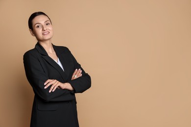 Photo of Confident business woman in suit on beige background. Space for text