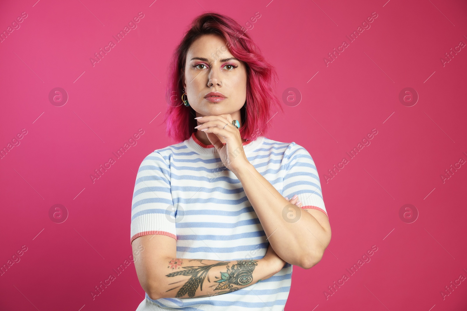 Beautiful woman with bright dyed hair on pink background Photo of Beautiful woman with bright dyed hair on pink background